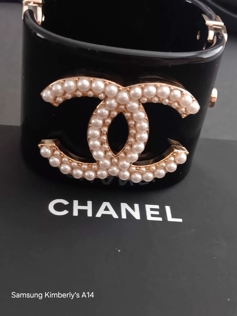 This item is a Chanel Pearl Logo Cuff Bracelet, typically crafted.
